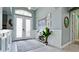 Inviting foyer with decorative double doors, stylish decor, and a charming console table at 16612 5Th E Ave, Bradenton, FL 34212