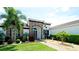 Beautiful home exterior featuring a well-manicured lawn, lush landscaping, and a striking stone facade at 16612 5Th E Ave, Bradenton, FL 34212