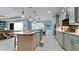 Stylish kitchen with a large island, pendant lighting, stainless steel appliances, and an open layout at 16612 5Th E Ave, Bradenton, FL 34212