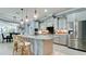 Beautiful kitchen with gray cabinets, granite counters, stainless steel appliances, and island with bar seating at 16612 5Th E Ave, Bradenton, FL 34212