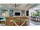 Inviting living room featuring a stone fireplace, contemporary decor, and sliding glass doors to the patio at 16612 5Th E Ave, Bradenton, FL 34212