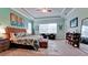 Spacious main bedroom with a tray ceiling, ample natural light, and cozy seating area at 16612 5Th E Ave, Bradenton, FL 34212