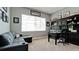 Home office with a large window, a dark desk, rolling chair, and ample storage and display shelves at 16612 5Th E Ave, Bradenton, FL 34212