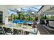 A view of the outdoor dining and kitchen space overlooking the pool and screened lanai at 16612 5Th E Ave, Bradenton, FL 34212