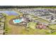 Panoramic aerial view showcasing a community pool, playground, and basketball court surrounded by lush landscaping and modern homes at 16633 Sunburst Lake S St, Wimauma, FL 33598