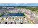 High aerial view of the neighborhood featuring a large pond and rows of houses at 16633 Sunburst Lake S St, Wimauma, FL 33598