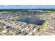 Breathtaking aerial perspective of a lakeside community featuring modern homes and lush greenery, all under a picturesque blue sky at 16633 Sunburst Lake S St, Wimauma, FL 33598