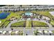 Overhead shot of a community pool and play area showcasing well-manicured lawns, a refreshing pool, and ample parking space at 16633 Sunburst Lake S St, Wimauma, FL 33598
