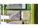 An aerial view of the roof, backyard and neighborhood including a calming pond at 16633 Sunburst Lake S St, Wimauma, FL 33598