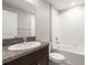 Bathroom features a granite-topped vanity, a sink, a toilet, and a tiled tub/shower combo at 16633 Sunburst Lake S St, Wimauma, FL 33598