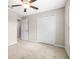 Bedroom showcasing carpet floors, ceiling fan, and closet doors for ample storage at 16633 Sunburst Lake S St, Wimauma, FL 33598
