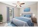 Bedroom featuring calming light blue accents, a ceiling fan, natural light, and decorative wall art at 16633 Sunburst Lake S St, Wimauma, FL 33598
