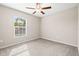 Cozy bedroom features neutral paint, plush carpeting, and a window for natural light at 16633 Sunburst Lake S St, Wimauma, FL 33598