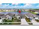 Beautiful home exterior showcasing landscaping, driveway, and serene lake backdrop at 16633 Sunburst Lake S St, Wimauma, FL 33598