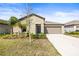 Charming single-story home with a two-car garage and nicely landscaped front yard at 16633 Sunburst Lake S St, Wimauma, FL 33598