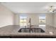 Close-up of kitchen island featuring a stainless steel sink and granite countertop at 16633 Sunburst Lake S St, Wimauma, FL 33598