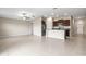 Open-concept living area with a view of the kitchen, stainless steel appliances, and tile flooring at 16633 Sunburst Lake S St, Wimauma, FL 33598