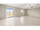 Spacious living room featuring tile flooring, ceiling fan, and sliding glass doors to the backyard at 16633 Sunburst Lake S St, Wimauma, FL 33598