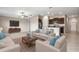 Open-concept living room and kitchen with modern appliances, breakfast bar, and lots of natural light at 16633 Sunburst Lake S St, Wimauma, FL 33598