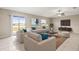 Bright living room with tile floors, a ceiling fan, and sliding glass doors that provide access to the outside at 16633 Sunburst Lake S St, Wimauma, FL 33598