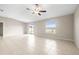 Bright, tiled living area with large sliding glass doors opening to the backyard at 16633 Sunburst Lake S St, Wimauma, FL 33598