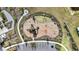 Aerial shot of a playground with modern equipment and safe, soft landing surfaces for enjoyment at 16633 Sunburst Lake S St, Wimauma, FL 33598