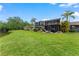 Backyard with a screened lanai, outdoor seating, and views of the pond at 170 Ingrid Pl, Oldsmar, FL 34677