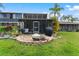 Screened lanai with a fire pit and grill, perfect for outdoor entertaining at 170 Ingrid Pl, Oldsmar, FL 34677
