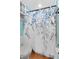 Bathroom boasting a decorative blue and gray floral shower curtain at 170 Ingrid Pl, Oldsmar, FL 34677