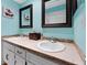 Bathroom featuring dual sinks, granite countertops, and decorative mirrors at 170 Ingrid Pl, Oldsmar, FL 34677