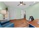 The bedroom has wood flooring, neutral walls, ceiling fan, and closet for optimal storage at 170 Ingrid Pl, Oldsmar, FL 34677
