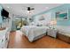 Coastal bedroom with blue accents, shiplap headboard, and a sliding glass door to the outside at 170 Ingrid Pl, Oldsmar, FL 34677