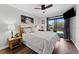 Cozy bedroom with a rustic wooden bed frame and a sliding glass door to the outside at 170 Ingrid Pl, Oldsmar, FL 34677