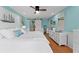 Comfortable bedroom featuring light blue walls, white furniture, and wood flooring at 170 Ingrid Pl, Oldsmar, FL 34677