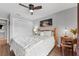 Relaxing bedroom featuring a wooden bed frame, white bedding, and wood flooring at 170 Ingrid Pl, Oldsmar, FL 34677
