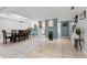 Open floorplan from dining area shows kitchen with white cabinetry and staircase to upper level at 170 Ingrid Pl, Oldsmar, FL 34677