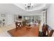 Spacious dining room with a large wooden table, chandelier, and open view to the living area at 170 Ingrid Pl, Oldsmar, FL 34677