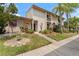 Inviting townhome exterior with a landscaped yard and charming front porch at 170 Ingrid Pl, Oldsmar, FL 34677