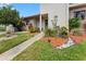 Attractive townhome entrance with a landscaped yard and a well-lit pathway at 170 Ingrid Pl, Oldsmar, FL 34677