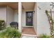 Inviting front entryway featuring a bench, plants, and decorative floral accents at 170 Ingrid Pl, Oldsmar, FL 34677