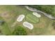Aerial shot of a well-manicured golf course green with sand bunkers at 170 Ingrid Pl, Oldsmar, FL 34677