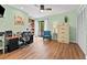 Inviting home office with wood floors, large window, ceiling fan, built-in bookshelves, and storage at 170 Ingrid Pl, Oldsmar, FL 34677