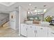 Bright kitchen area with white cabinets, granite countertops, and view into the dining and living area at 170 Ingrid Pl, Oldsmar, FL 34677
