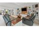 Cozy living room featuring comfortable seating, custom built-ins, and a rustic wood accent wall at 170 Ingrid Pl, Oldsmar, FL 34677