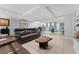 Open-concept living area with neutral tones, unique wooden coffee table, and seamless flow to dining at 170 Ingrid Pl, Oldsmar, FL 34677