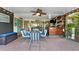 Enclosed outdoor patio with bar area, TV, and ample seating for entertaining and dining at 170 Ingrid Pl, Oldsmar, FL 34677