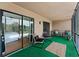Relaxing screened patio with comfortable seating and view to bedroom with sliding glass doors at 170 Ingrid Pl, Oldsmar, FL 34677