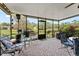 Relaxing screened-in porch with lovely views of the tranquil pond and surrounding greenery at 170 Ingrid Pl, Oldsmar, FL 34677