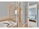Bathroom featuring a glass-enclosed shower with an adjacent bathtub, and a bedroom in view at 1742 Oakwood Estates Dr, Plant City, FL 33563