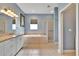 Bathroom featuring double sinks, a soaking tub, and a separate glass-enclosed shower at 1742 Oakwood Estates Dr, Plant City, FL 33563